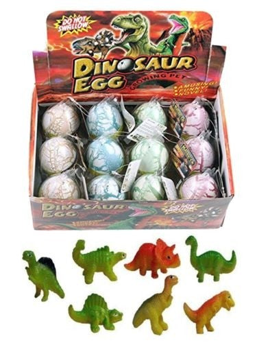 Display box holding 12 pastel-colored dinosaur eggs, with assorted toy dinosaur figures shown below.