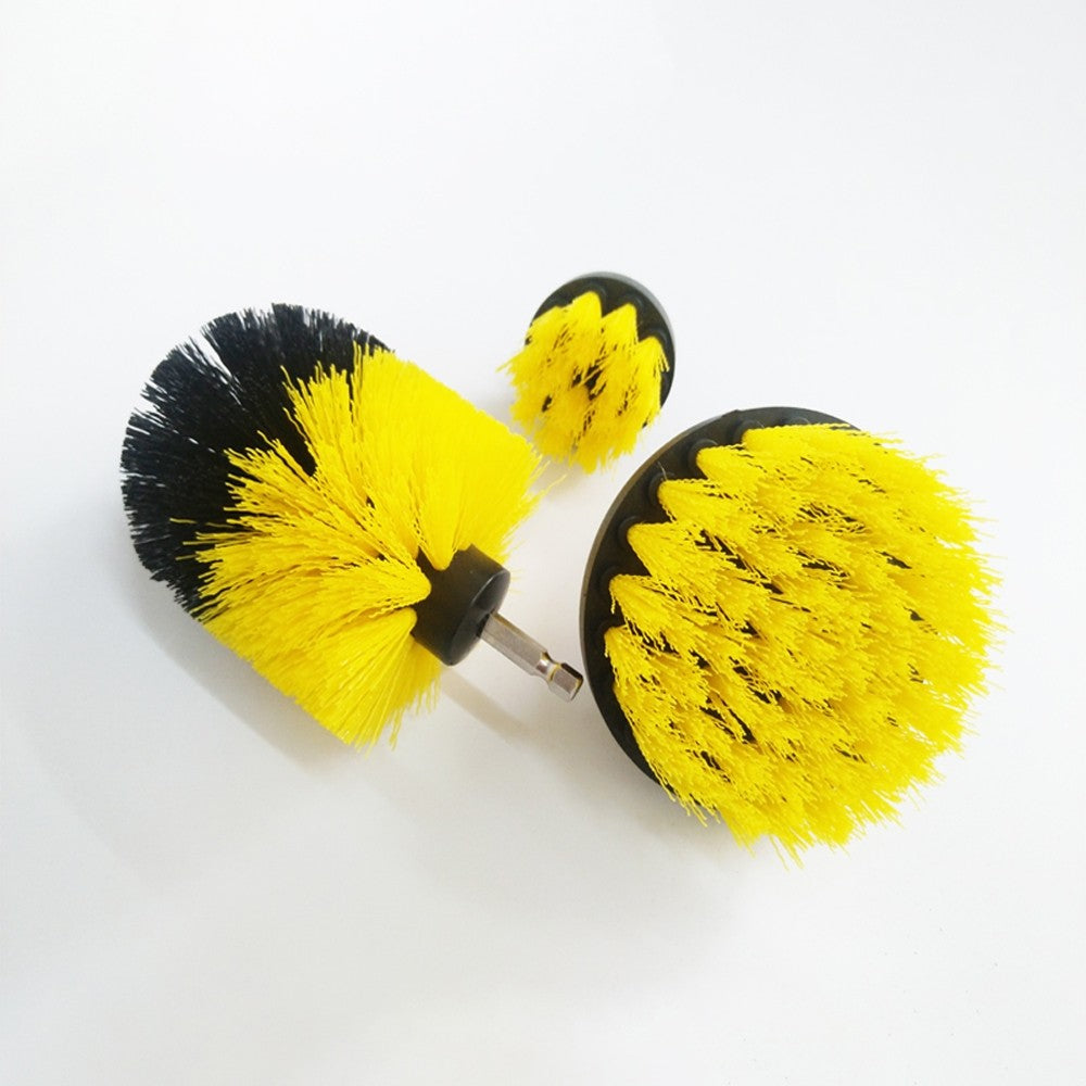 Angled view of three yellow and black drill brush attachments showing their bristles and different shapes.
