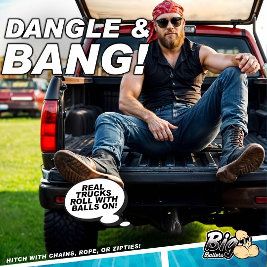 Truck nuts novelty decoration hanging from rear bumper hitch of a pickup truck.