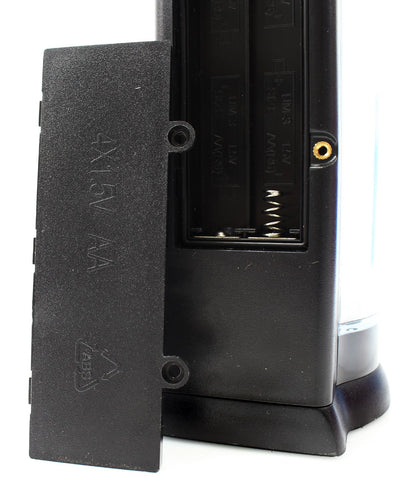 Open battery compartment on the back of the soap dispenser, with the cover removed and battery slots visible.