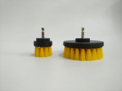 Small and large round drill brush attachments with yellow bristles, black bases, and metal shafts.